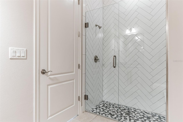 bathroom featuring tile patterned flooring and an enclosed shower