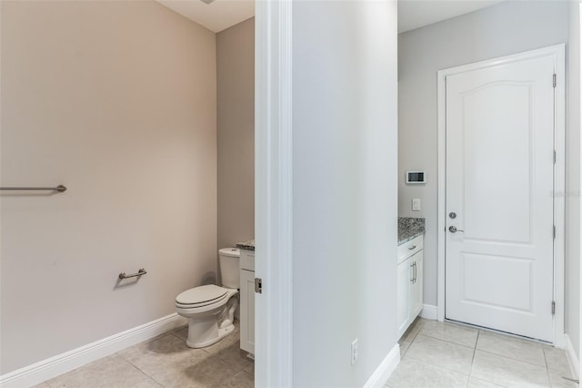 bathroom with tile patterned floors, vanity, and toilet