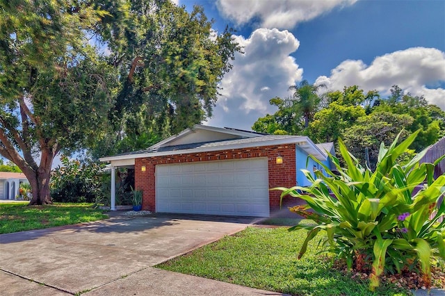 view of front of property featuring a front yard and a garage