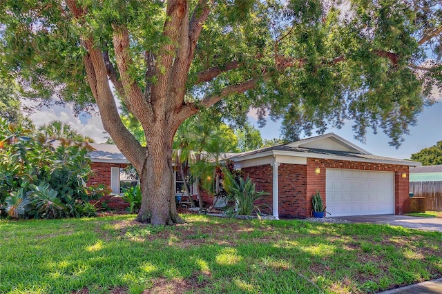 view of front of house featuring a garage and a front lawn