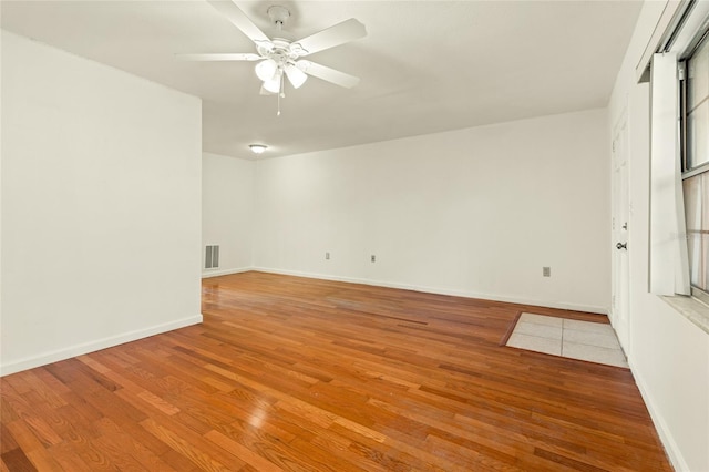 unfurnished room with ceiling fan and light wood-type flooring