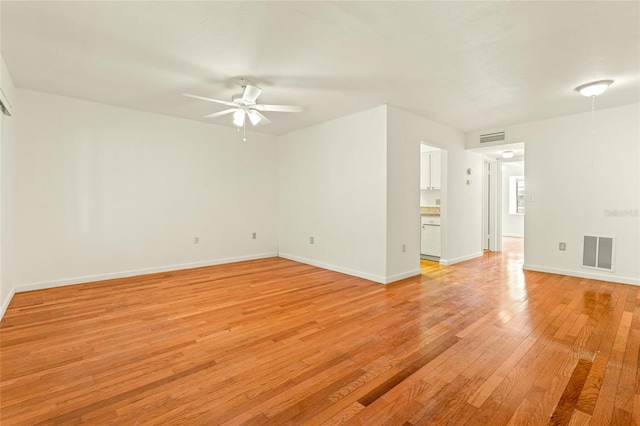 unfurnished room featuring ceiling fan and light wood-type flooring