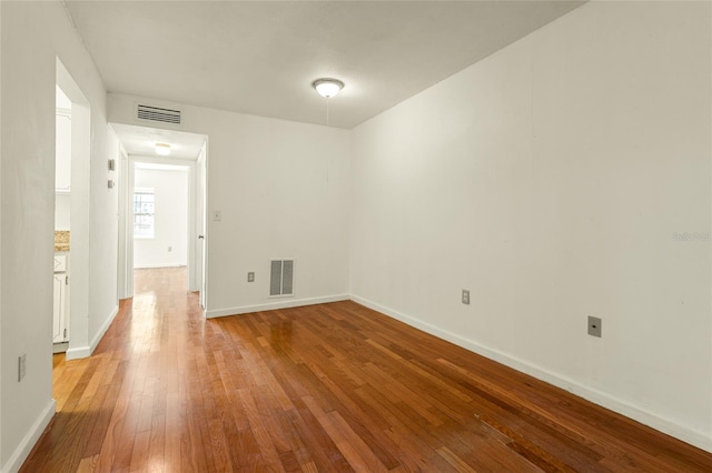 spare room with hardwood / wood-style flooring