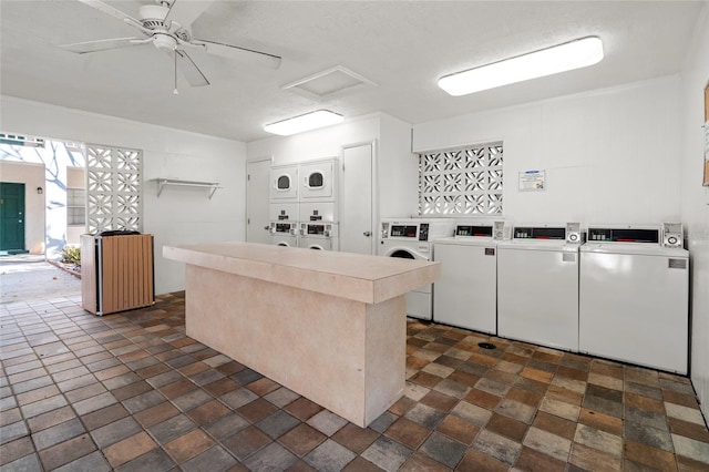 kitchen featuring white cabinets, washer and dryer, stacked washer and clothes dryer, and ceiling fan