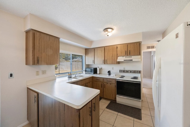 kitchen with kitchen peninsula, a textured ceiling, white appliances, sink, and light tile patterned flooring