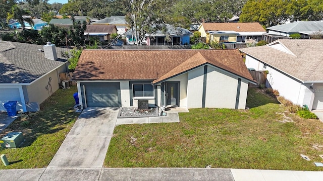 view of front facade with a front yard, central AC, and a garage