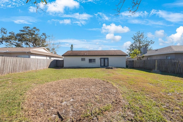 rear view of property featuring a yard