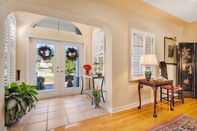 foyer entrance with french doors and wood-type flooring