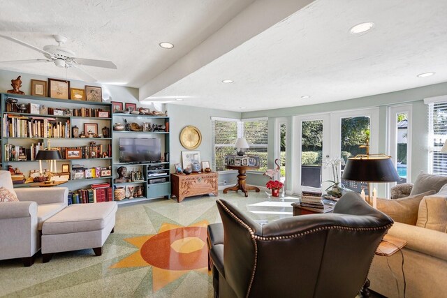 living room with carpet, ceiling fan, a textured ceiling, and french doors