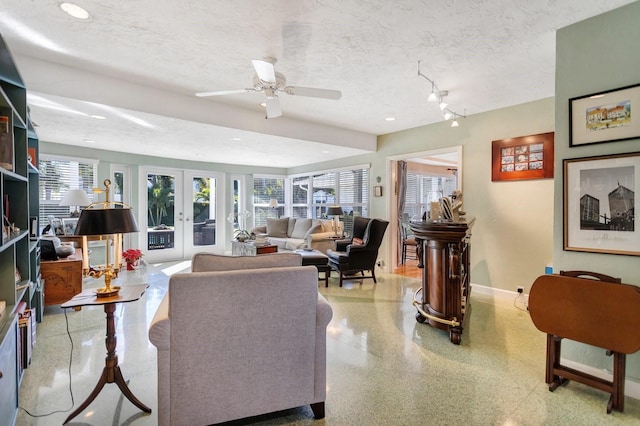 living room with french doors, a textured ceiling, track lighting, and ceiling fan