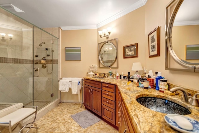 bathroom with vanity, a shower with door, and ornamental molding