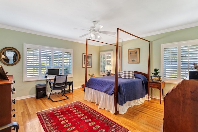 bedroom featuring hardwood / wood-style floors, ceiling fan, crown molding, and multiple windows