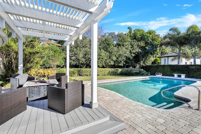 view of swimming pool featuring a pergola, a patio, and an outdoor fire pit