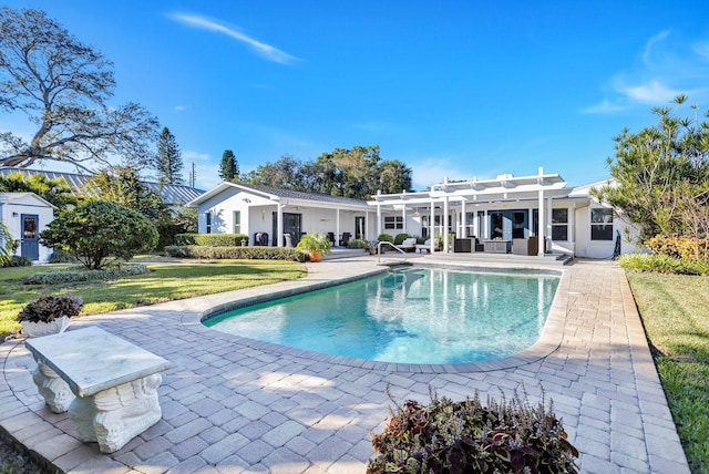 view of pool with a pergola, a patio area, and a lawn