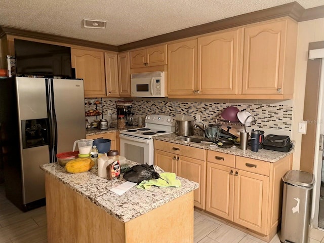 kitchen featuring light stone countertops, sink, white appliances, decorative backsplash, and light brown cabinetry