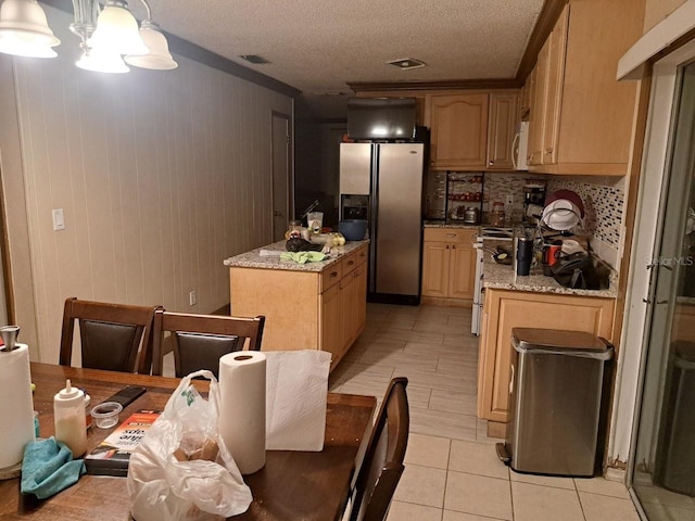 kitchen with tasteful backsplash, pendant lighting, a textured ceiling, and appliances with stainless steel finishes