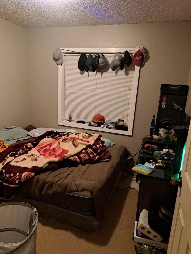 carpeted bedroom with a textured ceiling