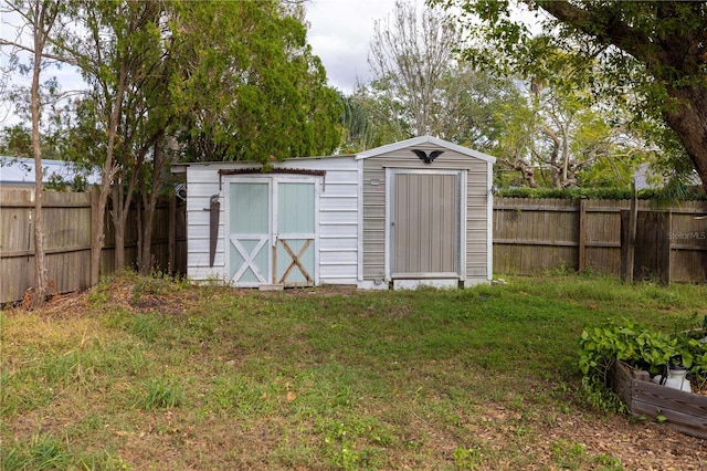 view of outbuilding featuring a lawn