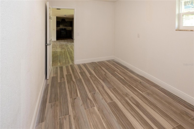 unfurnished room with hardwood / wood-style flooring