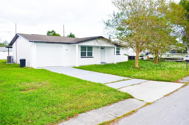 single story home featuring a garage and a front lawn