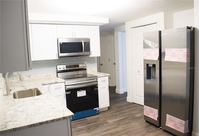 kitchen with dark hardwood / wood-style floors, sink, white cabinetry, and stainless steel appliances