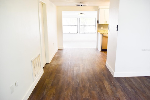 corridor featuring dark hardwood / wood-style flooring