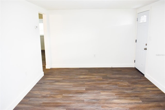 spare room with dark wood-type flooring