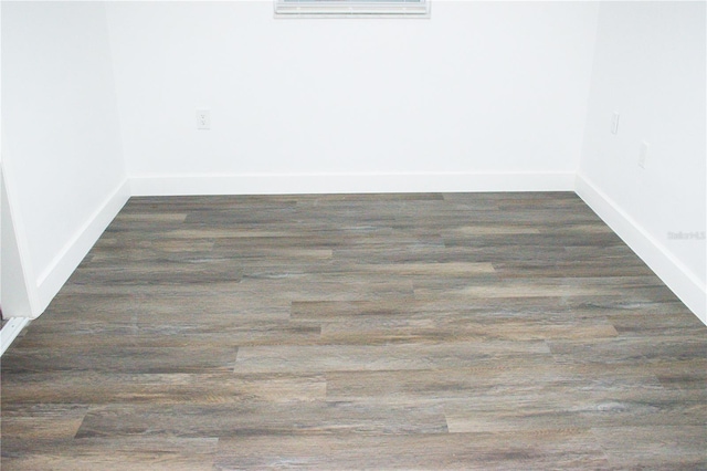 spare room featuring dark hardwood / wood-style floors