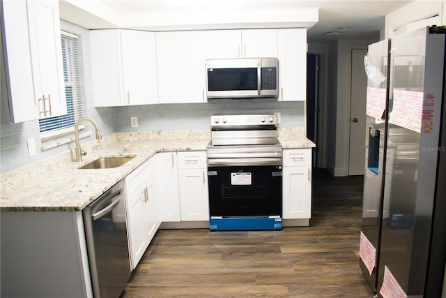 kitchen with dark hardwood / wood-style flooring, white cabinetry, sink, and appliances with stainless steel finishes