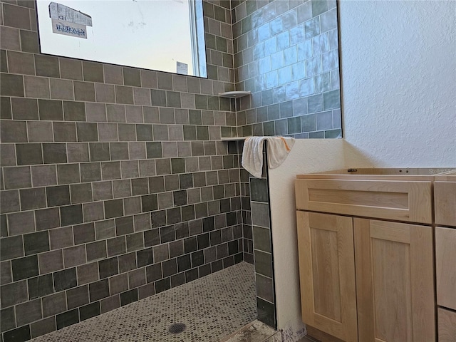 bathroom with a tile shower