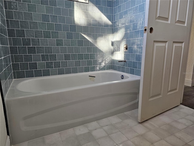 bathroom featuring tile patterned flooring and bathtub / shower combination