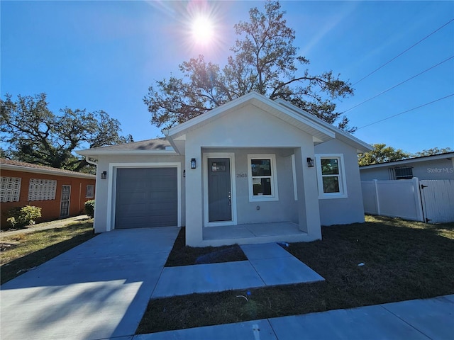 view of front facade with a garage, a front yard, and a porch