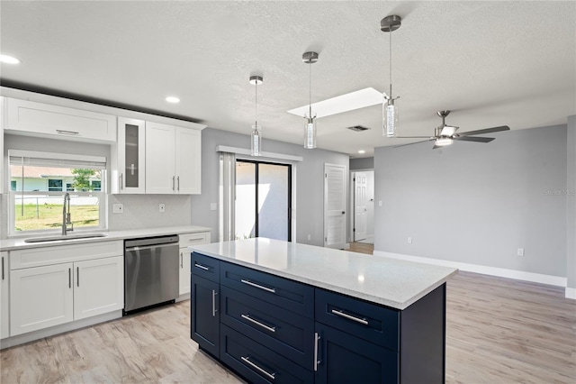 kitchen featuring a sink, a ceiling fan, visible vents, dishwasher, and white cabinets