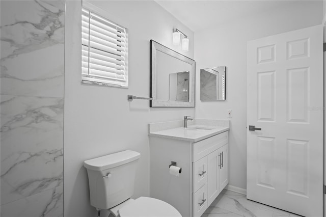 bathroom featuring vanity, toilet, and marble finish floor