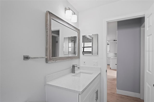 bathroom with wood finished floors and vanity