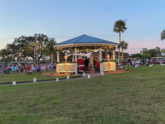 playground at dusk featuring a gazebo and a yard