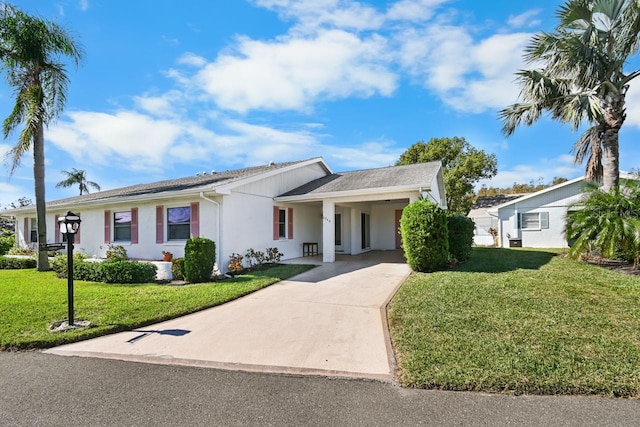 single story home featuring a carport and a front lawn