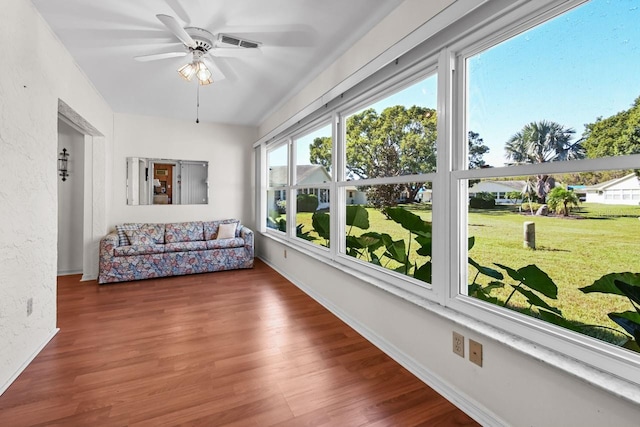 sunroom / solarium featuring ceiling fan