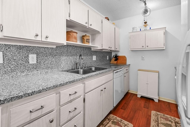 kitchen featuring tasteful backsplash, a textured ceiling, sink, dishwasher, and dark hardwood / wood-style floors