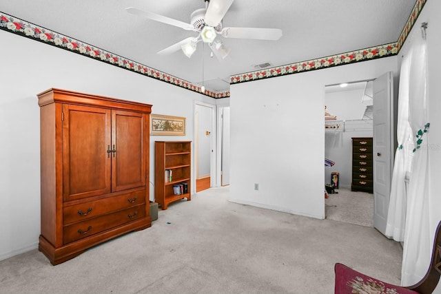 carpeted bedroom with a textured ceiling, a closet, and ceiling fan