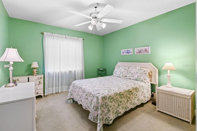 carpeted bedroom featuring ceiling fan and radiator