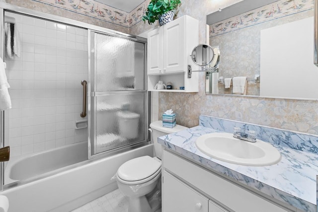 full bathroom featuring combined bath / shower with glass door, vanity, and toilet