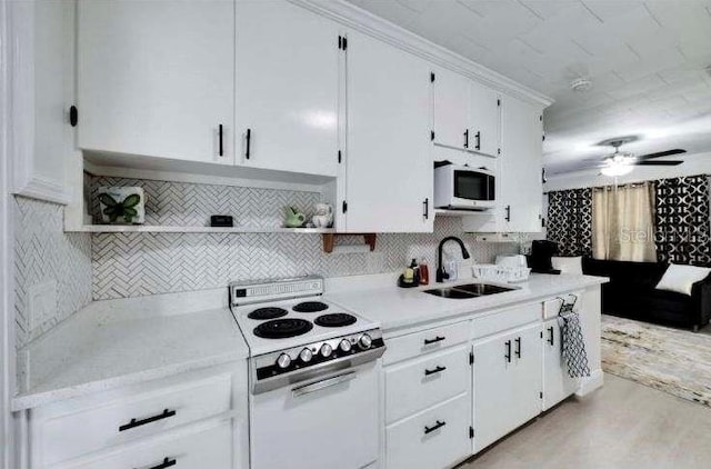 kitchen featuring backsplash, white appliances, ceiling fan, sink, and white cabinets