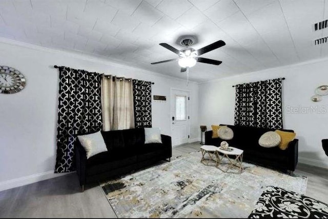 living room with crown molding, ceiling fan, and hardwood / wood-style flooring