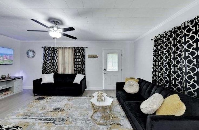 living room featuring hardwood / wood-style flooring, ceiling fan, and ornamental molding