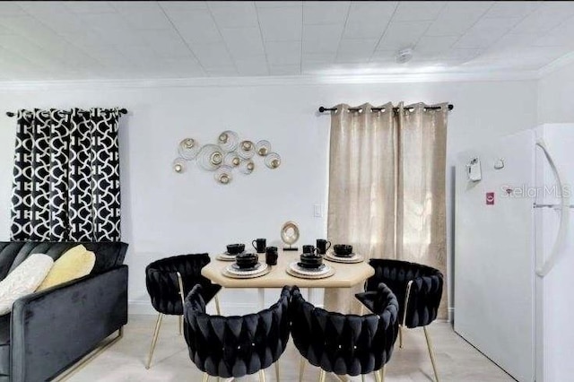 dining room featuring crown molding