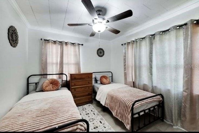 bedroom with ornamental molding and ceiling fan