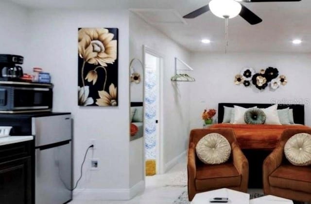 bedroom with stainless steel fridge and ceiling fan