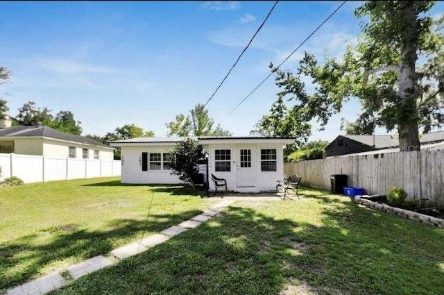 back of house with a lawn