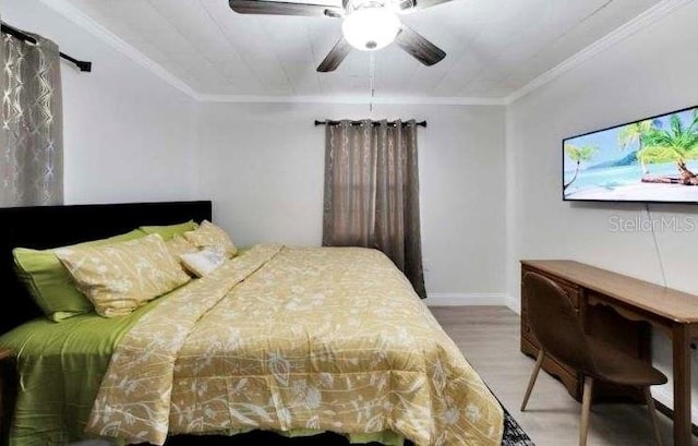 bedroom with hardwood / wood-style flooring, ceiling fan, and ornamental molding